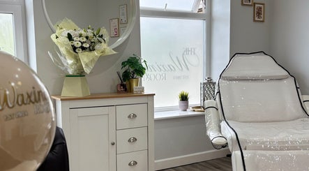 Luxurious treatment chair at The Waxing Room, Pencoed, Wales, GB, with bright decor and calming ambiance.