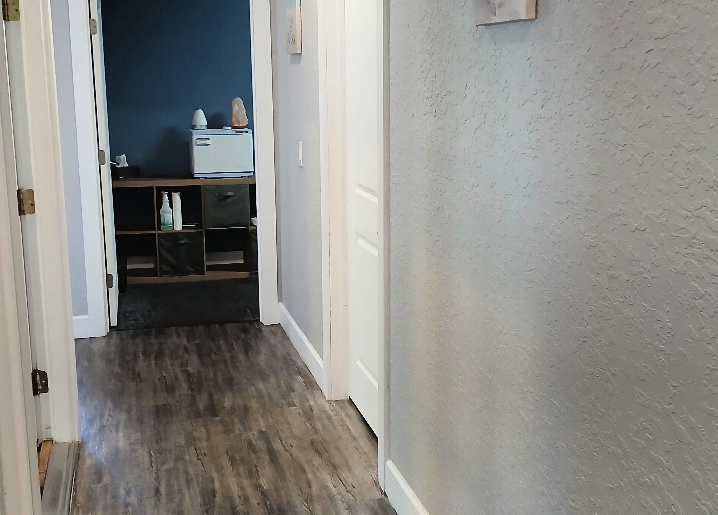 Calming hallway at Massageology in Middleburg, Florida, US with elegant decor and soft lighting.
