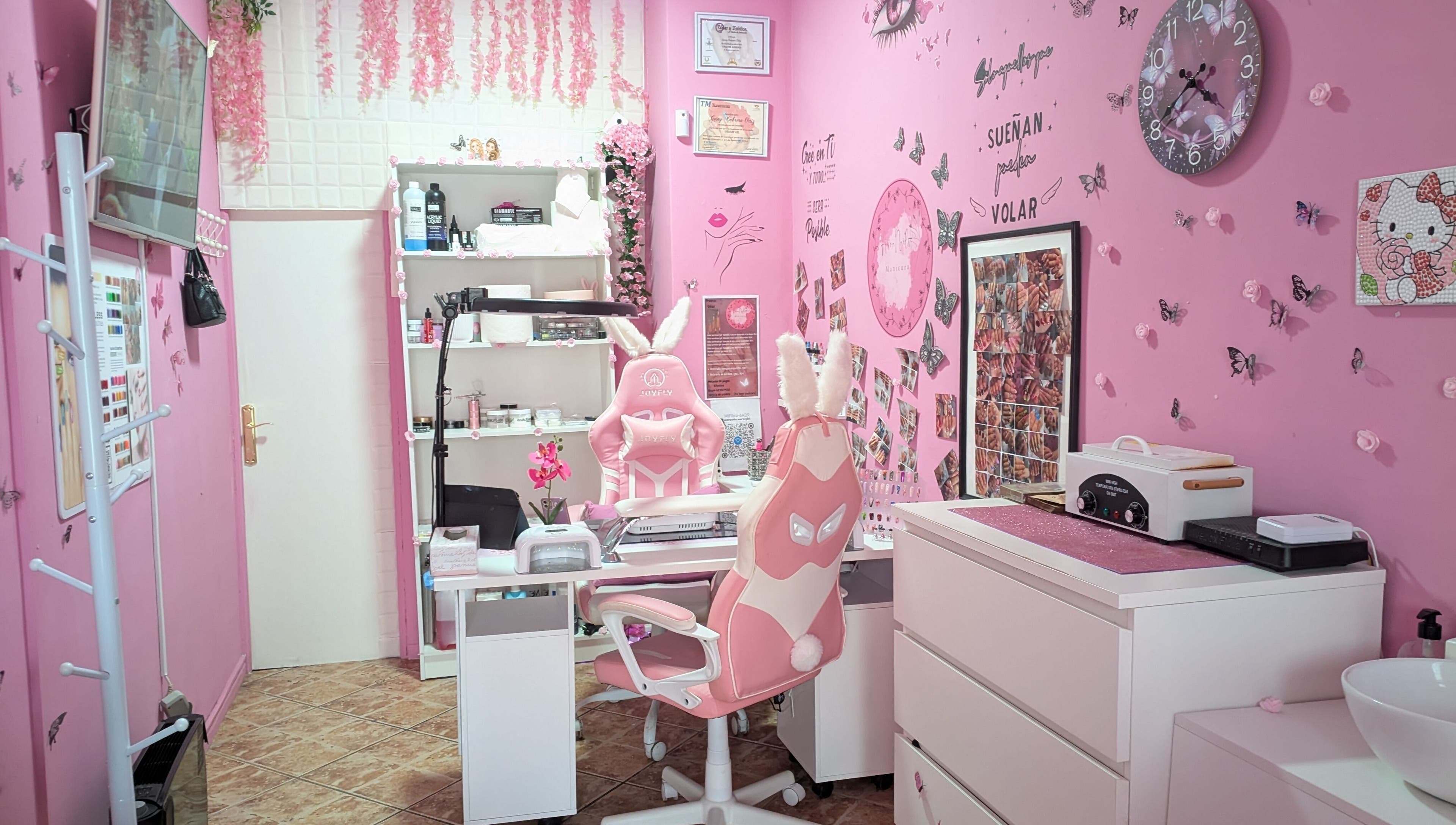 Interior rosa de Aroa Nails en Etxebarri, Euskadi, ES, decorado con mariposas y arte de uñas.