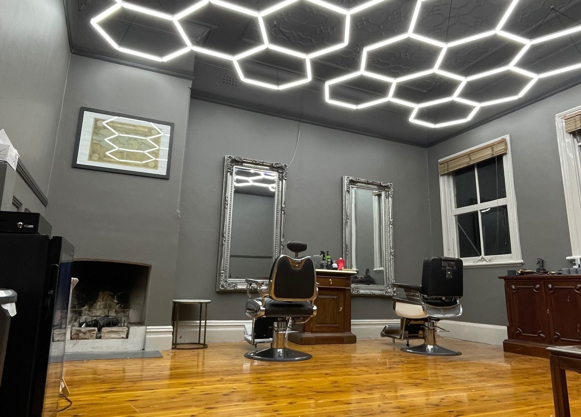 Modern barber chairs and mirrors at Kingdom Barbers & Co., Tamworth, New South Wales, AU.