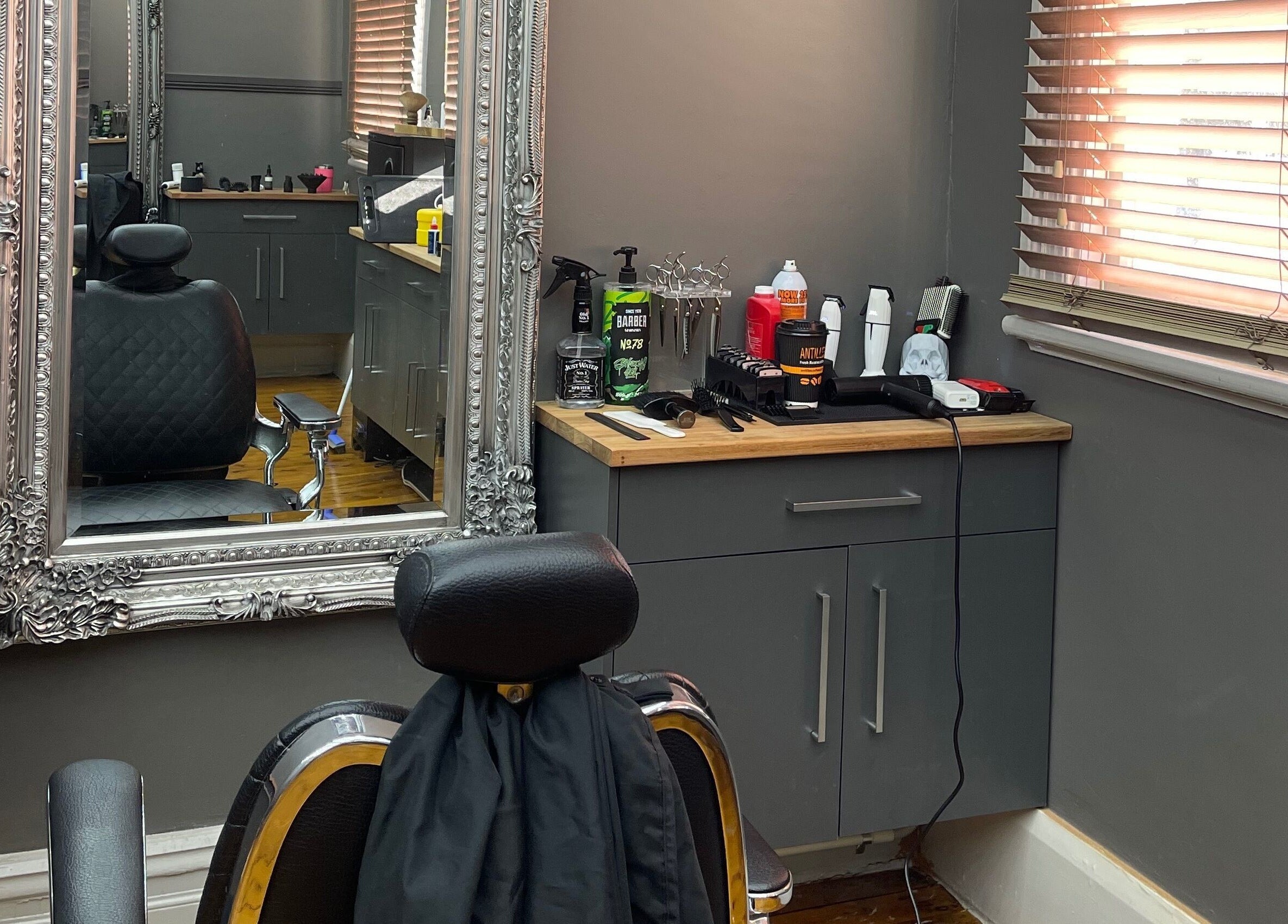 Chic barber station at Kingdom Barbers & Co., Tamworth, New South Wales, AU showcasing tools and sleek decor.