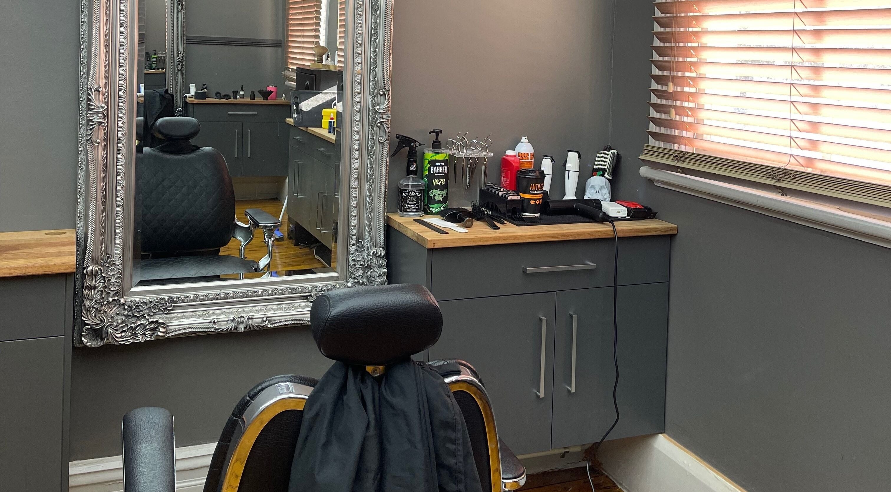 Chic barber station at Kingdom Barbers & Co., Tamworth, New South Wales, AU showcasing tools and sleek decor.