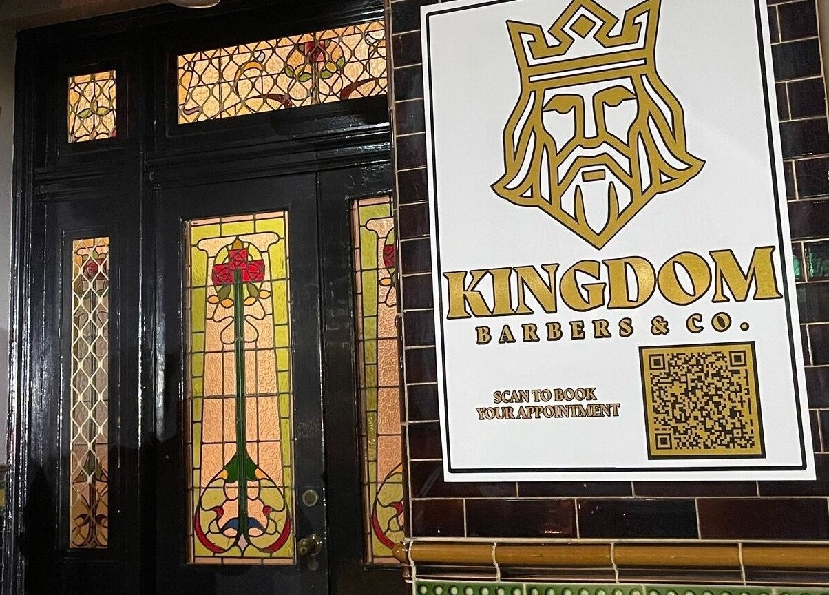 Entrance of Kingdom Barbers & Co. in Tamworth, New South Wales, AU showcasing stylish stained glass.