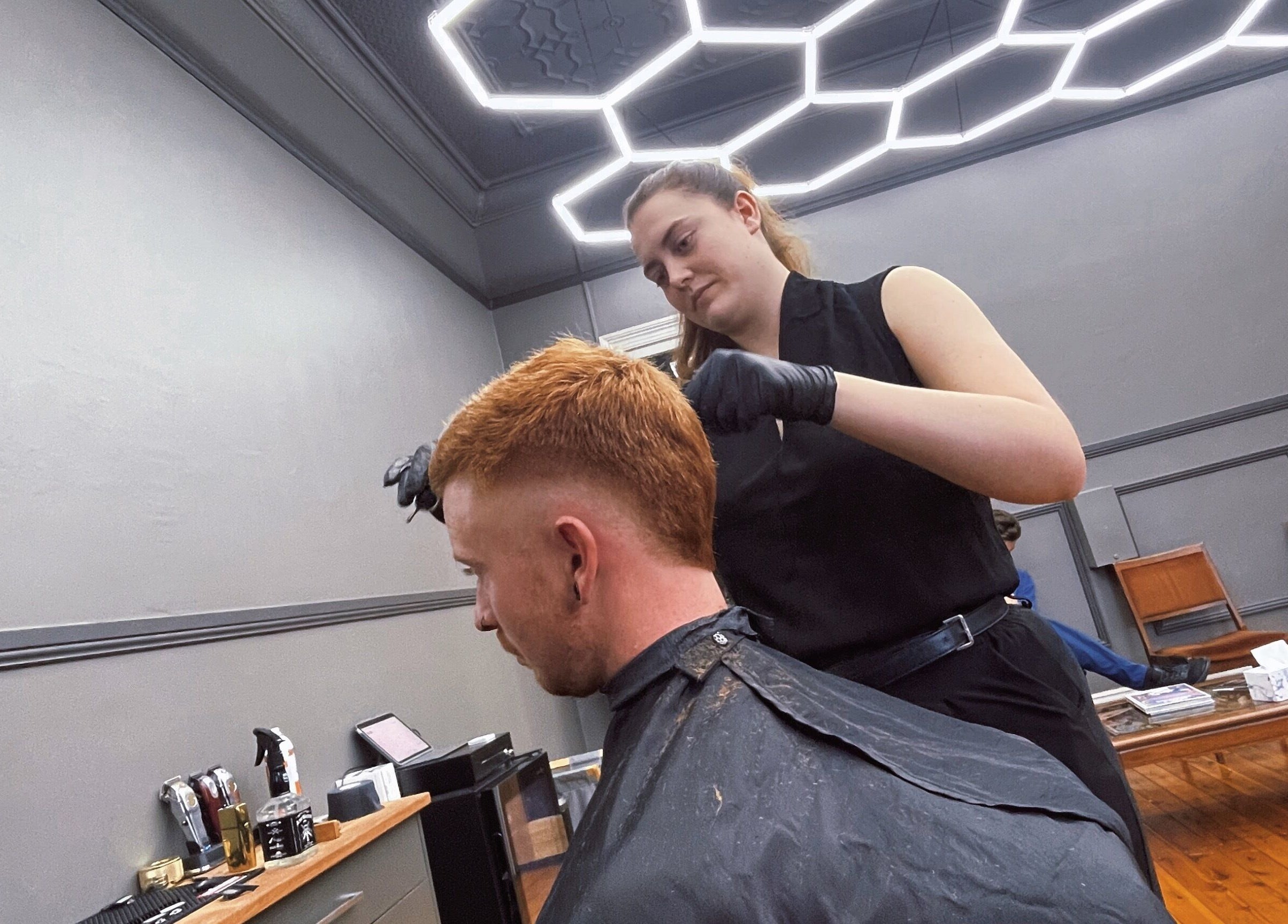 Stylist perfects haircut at Kingdom Barbers & Co., Tamworth, New South Wales, AU.