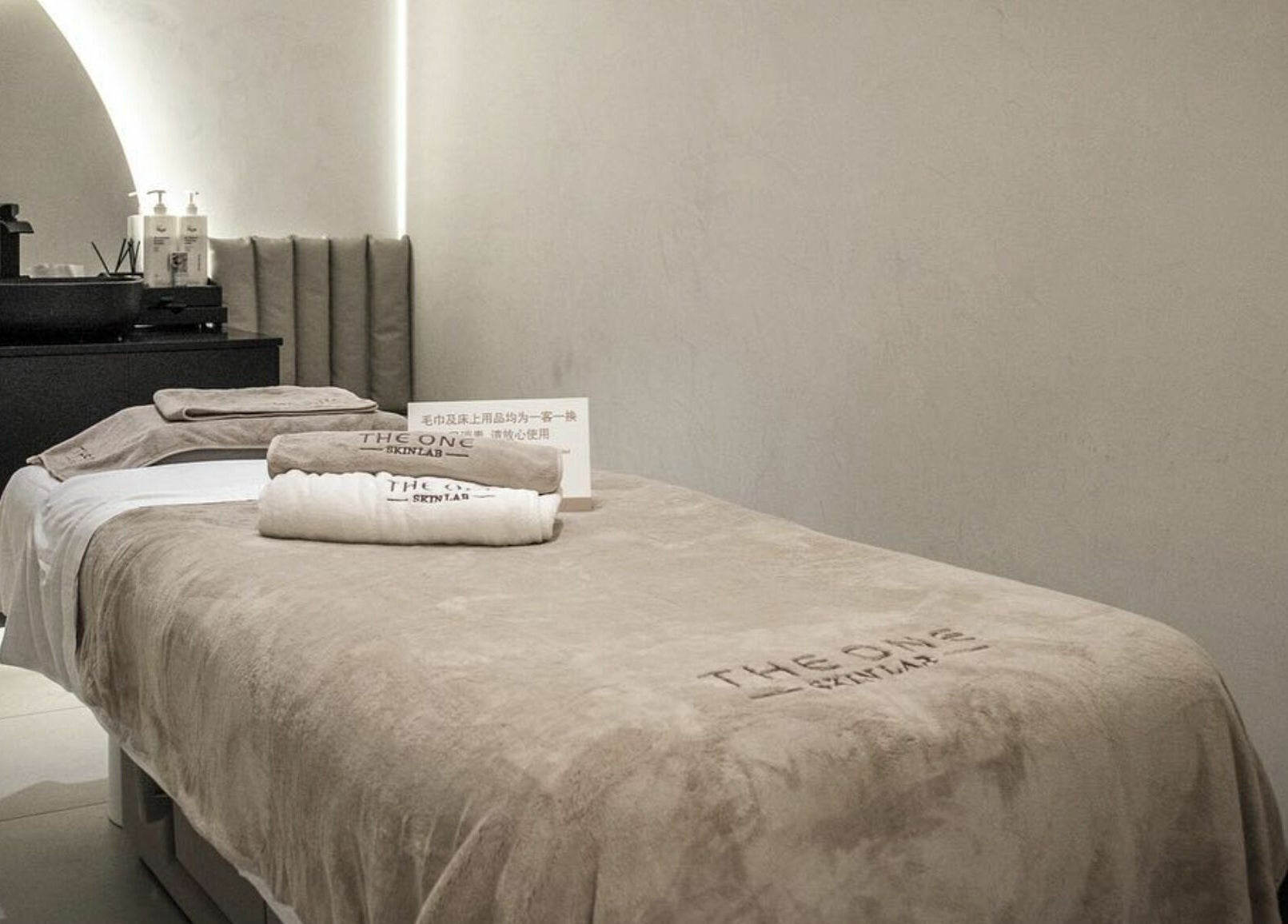 Tranquil spa suite at The One Skin Lab - QVB, Sydney, New South Wales, AU, featuring a cozy treatment bed and elegant decor.