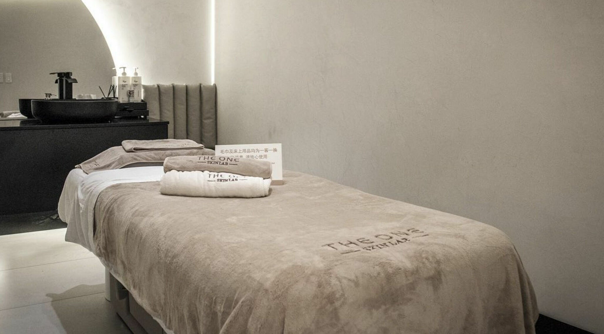 Tranquil spa suite at The One Skin Lab - QVB, Sydney, New South Wales, AU, featuring a cozy treatment bed and elegant decor.