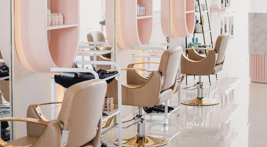 Modern salon interior at Bali Luxury Hair in Bali, Bali, ID with chic beige chairs and sleek design.