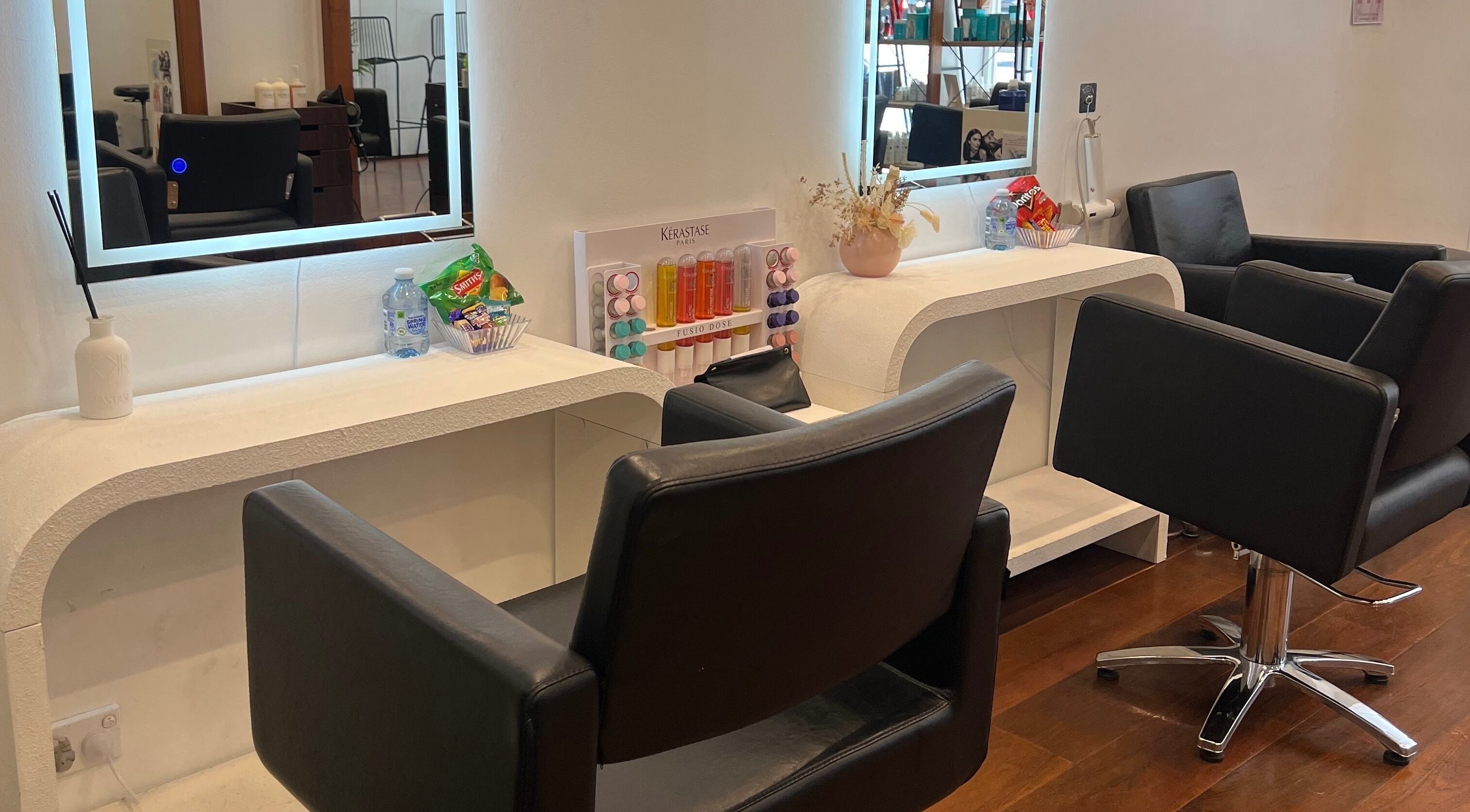 Modern salon chairs at Q Hair Melbourne, Victoria, AU. Sleek design with professional styling stations.