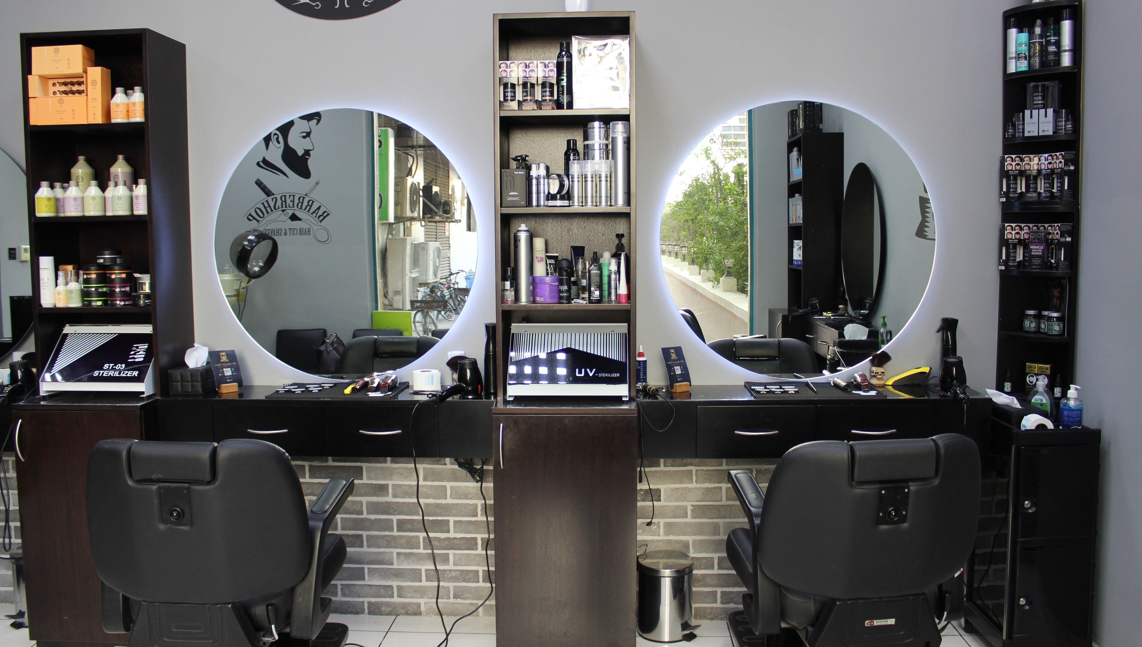 Interior of White Tower Salon صالون البرج الأبيض - Sheikh Zayed Road, Dubai, AE showcasing barber chairs and products.