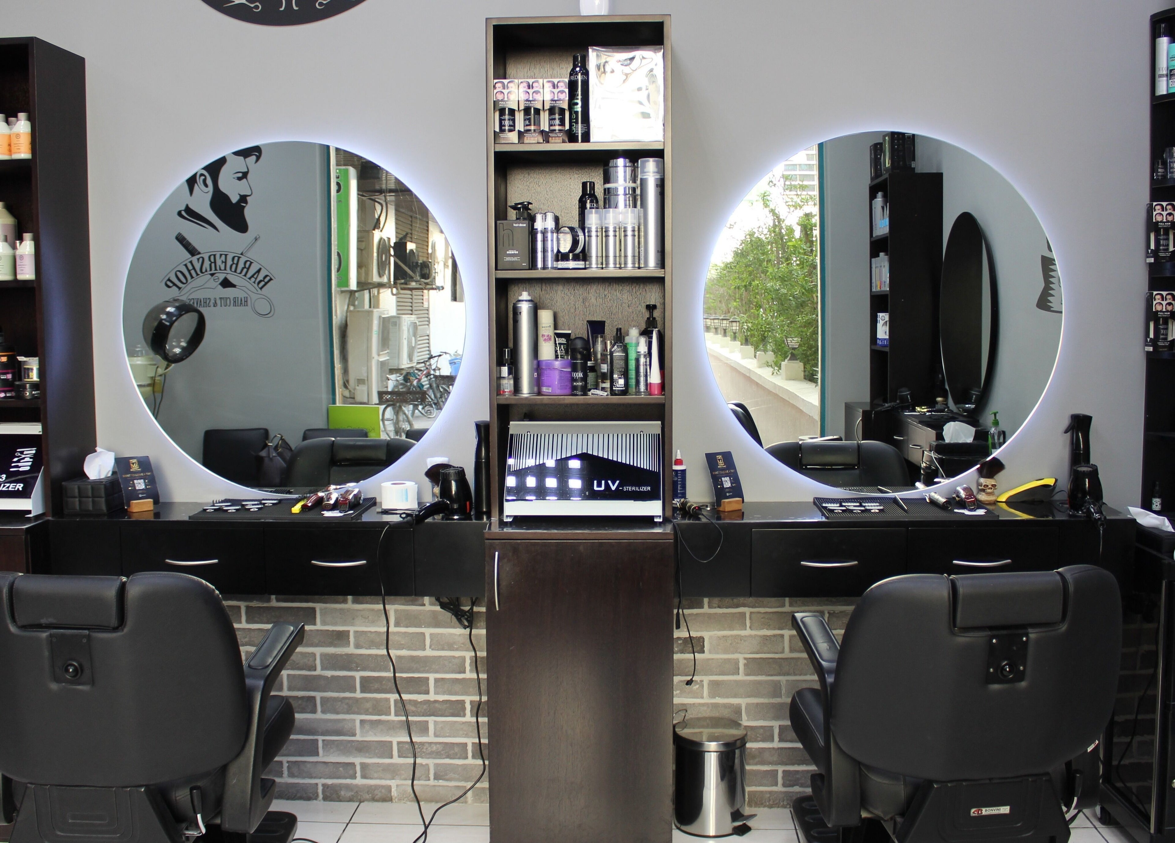 Interior of White Tower Salon صالون البرج الأبيض - Sheikh Zayed Road, Dubai, AE showcasing barber chairs and products.