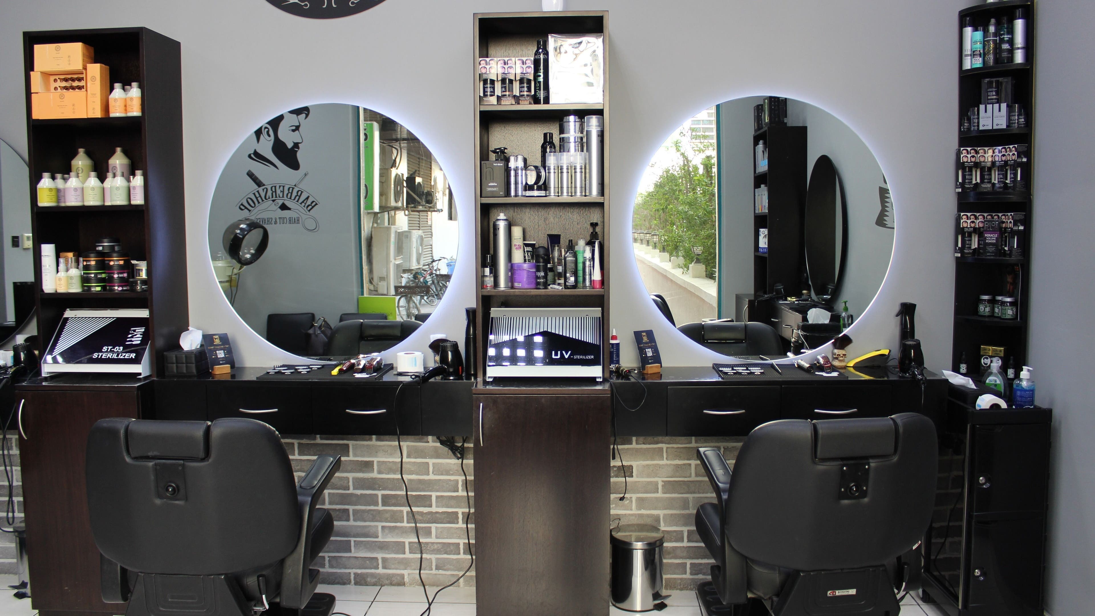Interior of White Tower Salon صالون البرج الأبيض - Sheikh Zayed Road, Dubai, AE showcasing barber chairs and products.