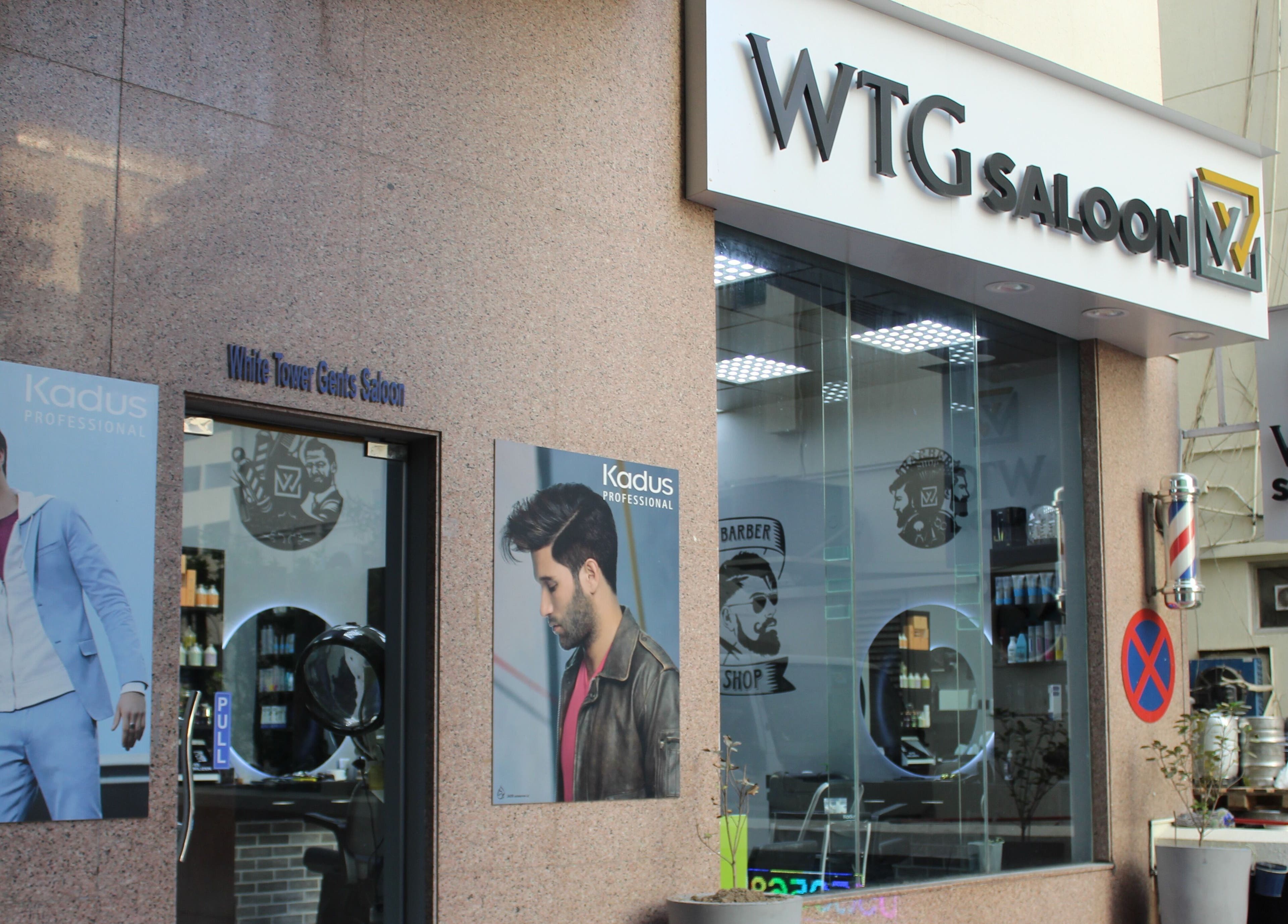 Exterior of White Tower Salon صالون البرج الأبيض on Sheikh Zayed Road, showcasing vibrant posters, Dubai, Dubai, AE.