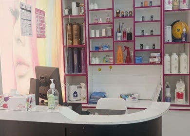 Reception area of Jamal Rosalina Ladies Salon, featuring a modern desk and shelves, Dubai, Dubai, AE.