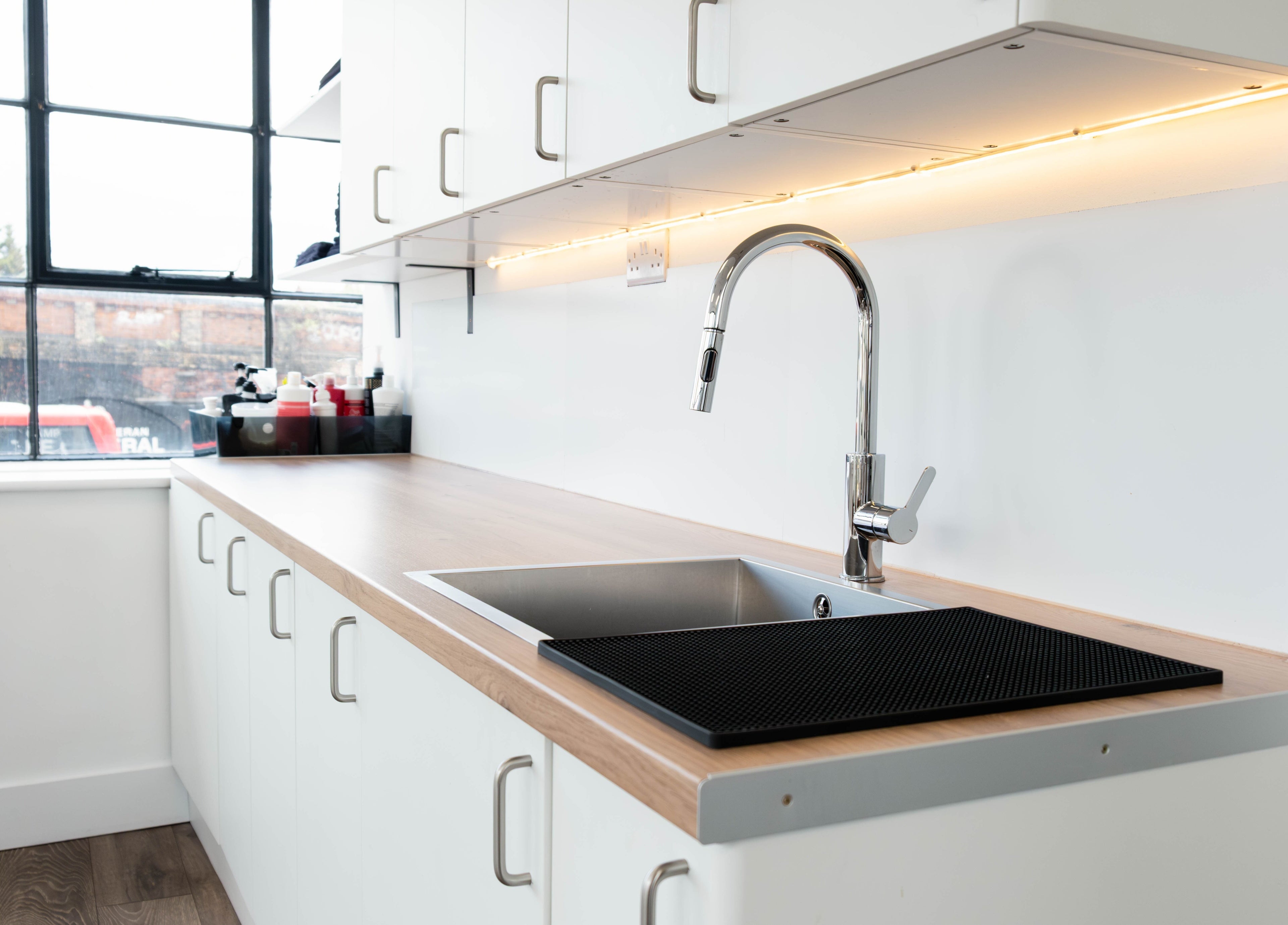 Modern salon sink area at Albert Di Guida Hair London, London, England, GB. Bright and spacious with sleek design.