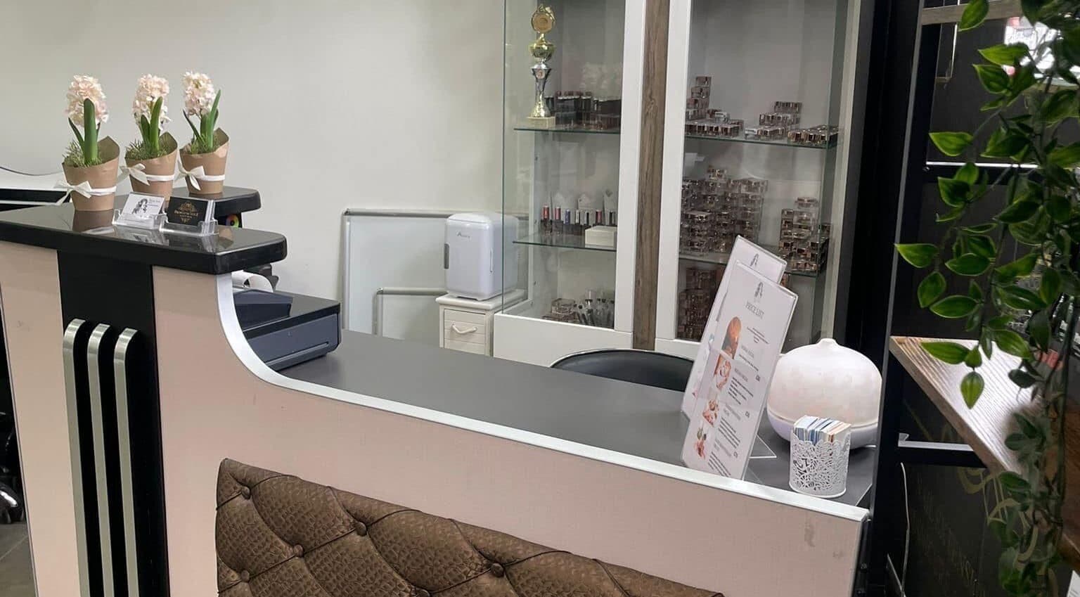 Reception area at Droplet Of Style, London, England, GB showcasing elegant decor and floral accents.