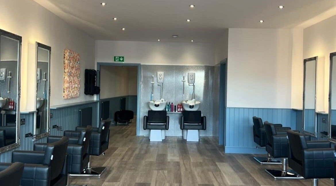 Modern salon interior at The Milano Hair & Beauty Suite, Larkhall, Scotland, GB with luxurious chairs and mirrors.