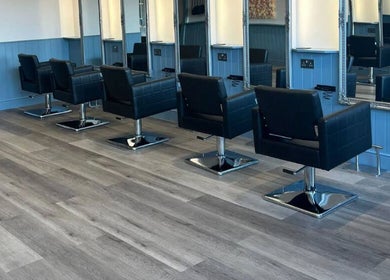 Modern salon chairs and mirrors at The Milano Hair & Beauty Suite in Larkhall, Scotland, GB.