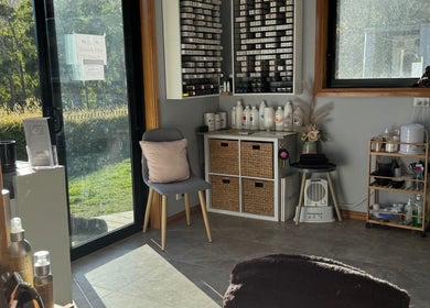 Cozy interior of Zo's Hidden Hair & Beauty in Ranelagh, Tasmania. Sunlit corner with hair products and a comfortable chair.