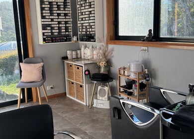 Bright interior of Zo's Hidden Hair & Beauty in Ranelagh, Tasmania, AU with stylish furnishings and hair products.