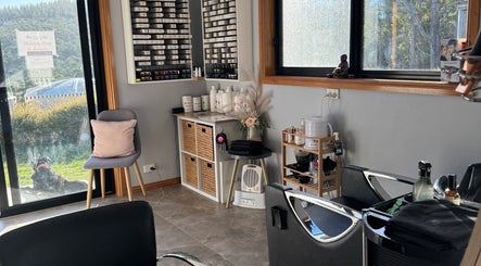 Bright interior of Zo's Hidden Hair & Beauty in Ranelagh, Tasmania, AU with stylish furnishings and hair products.