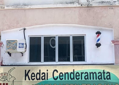 Front of Valgos Barbershop in Rawang, Selangor, MY featuring a classic barber pole sign.