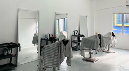 Interior of Valgos Barbershop in Rawang, Selangor, MY, showcasing sleek chairs and mirrors.