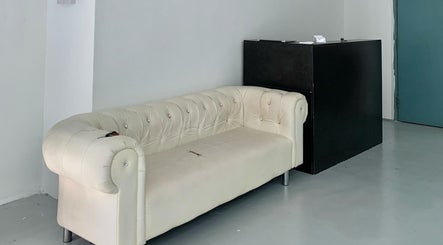 Comfortable white couch in waiting area of Hiraki Barbershop, Rawang, Selangor, MY.