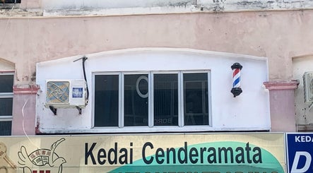 Hiraki Barbershop facade with iconic barber pole in Rawang, Selangor, MY.