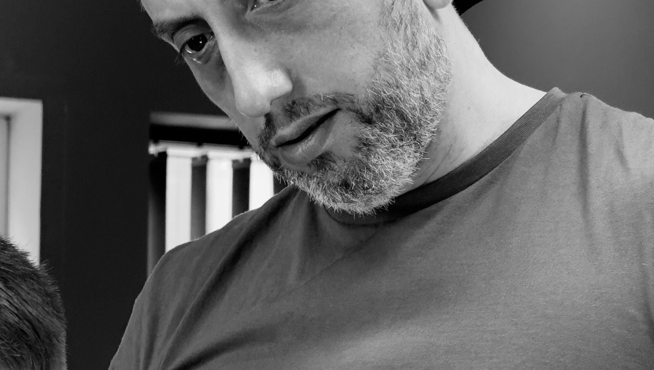 A barber at work in Harut’s Barbershop, Hoyvík, Streymoyar, FO, expertly styling a haircut.