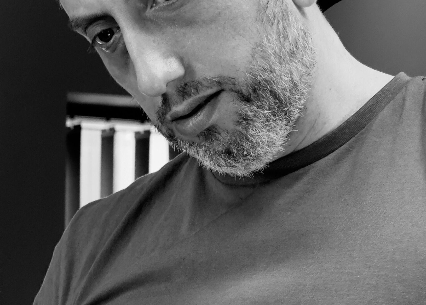 A barber at work in Harut’s Barbershop, Hoyvík, Streymoyar, FO, expertly styling a haircut.