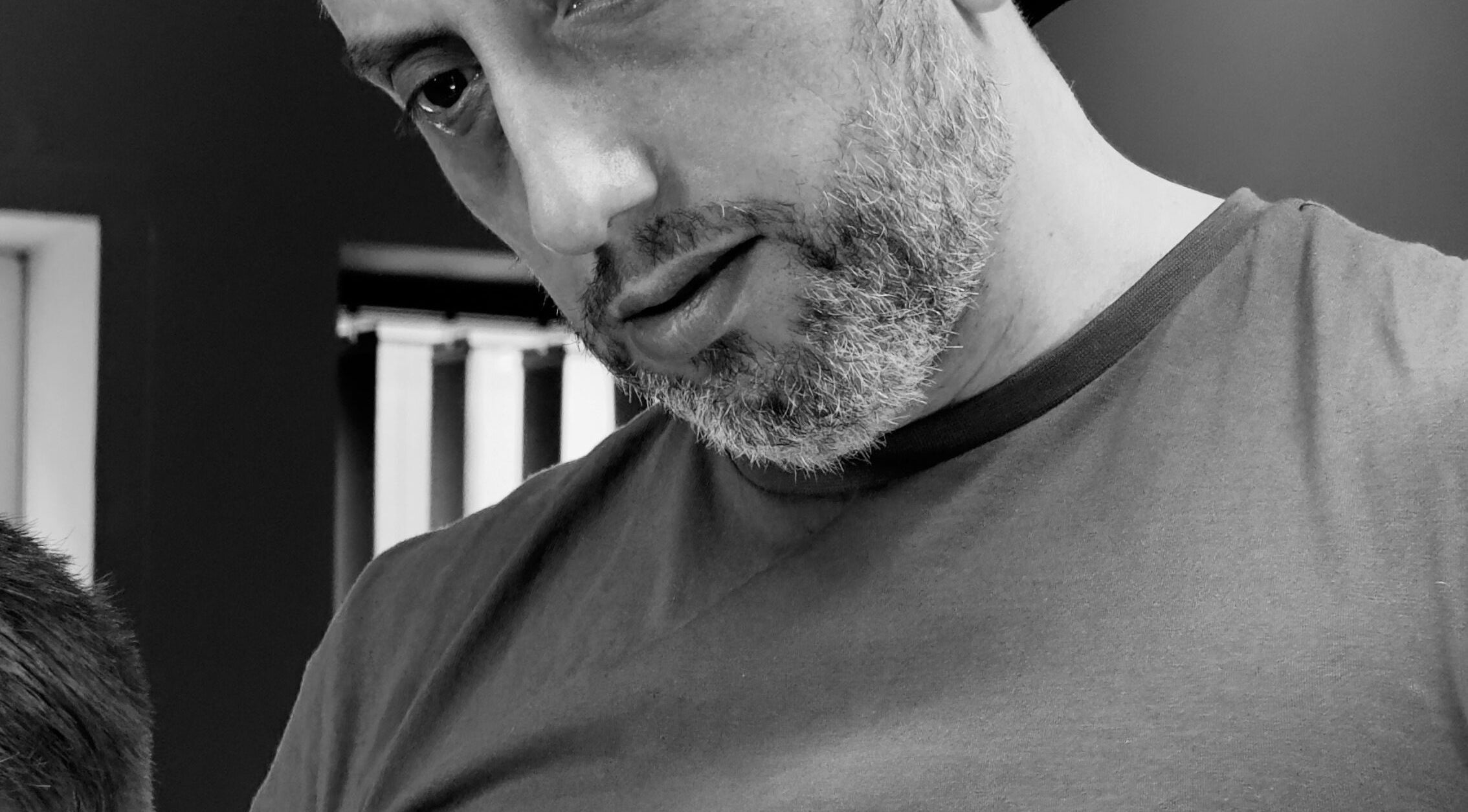 A barber at work in Harut’s Barbershop, Hoyvík, Streymoyar, FO, expertly styling a haircut.