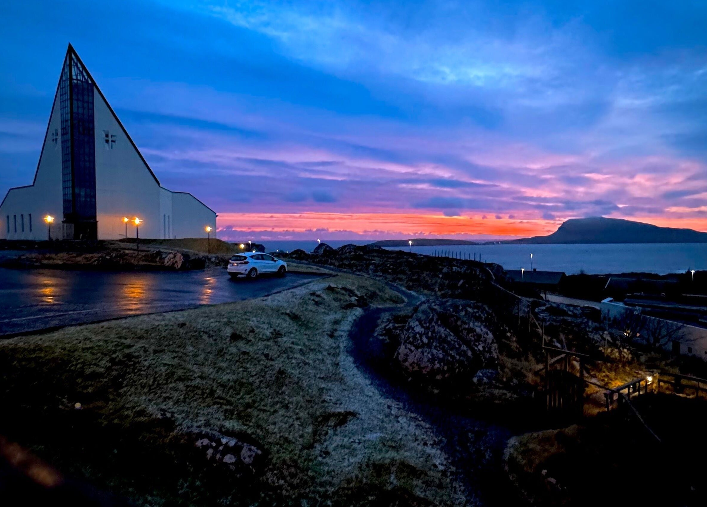 Spectacular sunset view near Harut’s Barbershop, Hoyvík, Streymoyar, FO showcasing stunning purple skies.