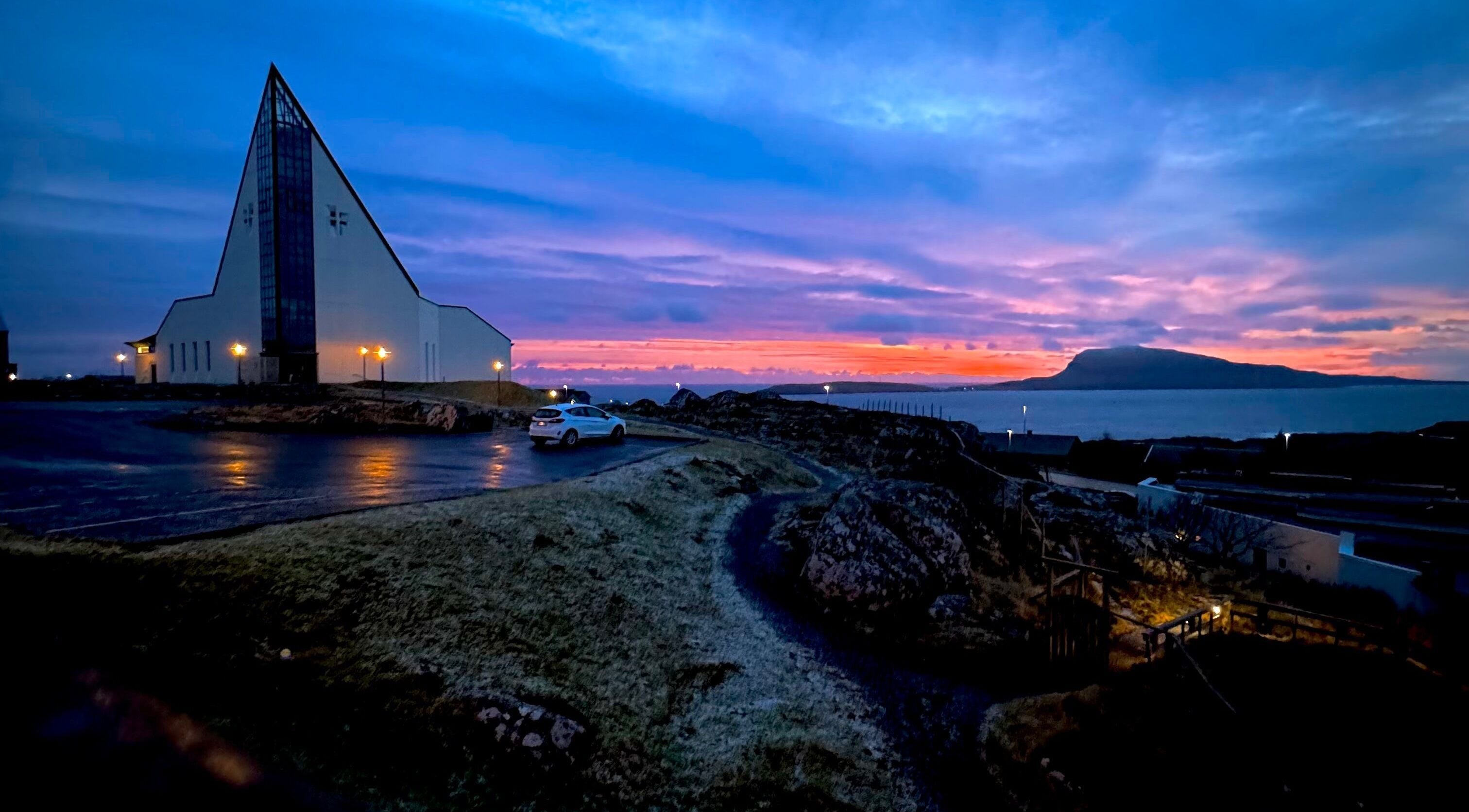 Spectacular sunset view near Harut’s Barbershop, Hoyvík, Streymoyar, FO showcasing stunning purple skies.