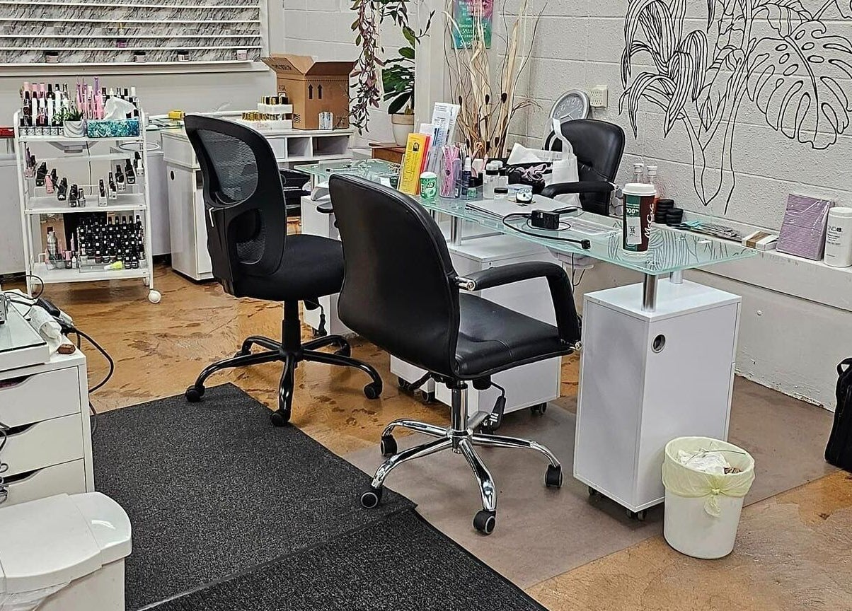 Modern nail station at Canopy Salon and Spa, Innisfail, Alberta, CA. Sleek chairs and organized tools.