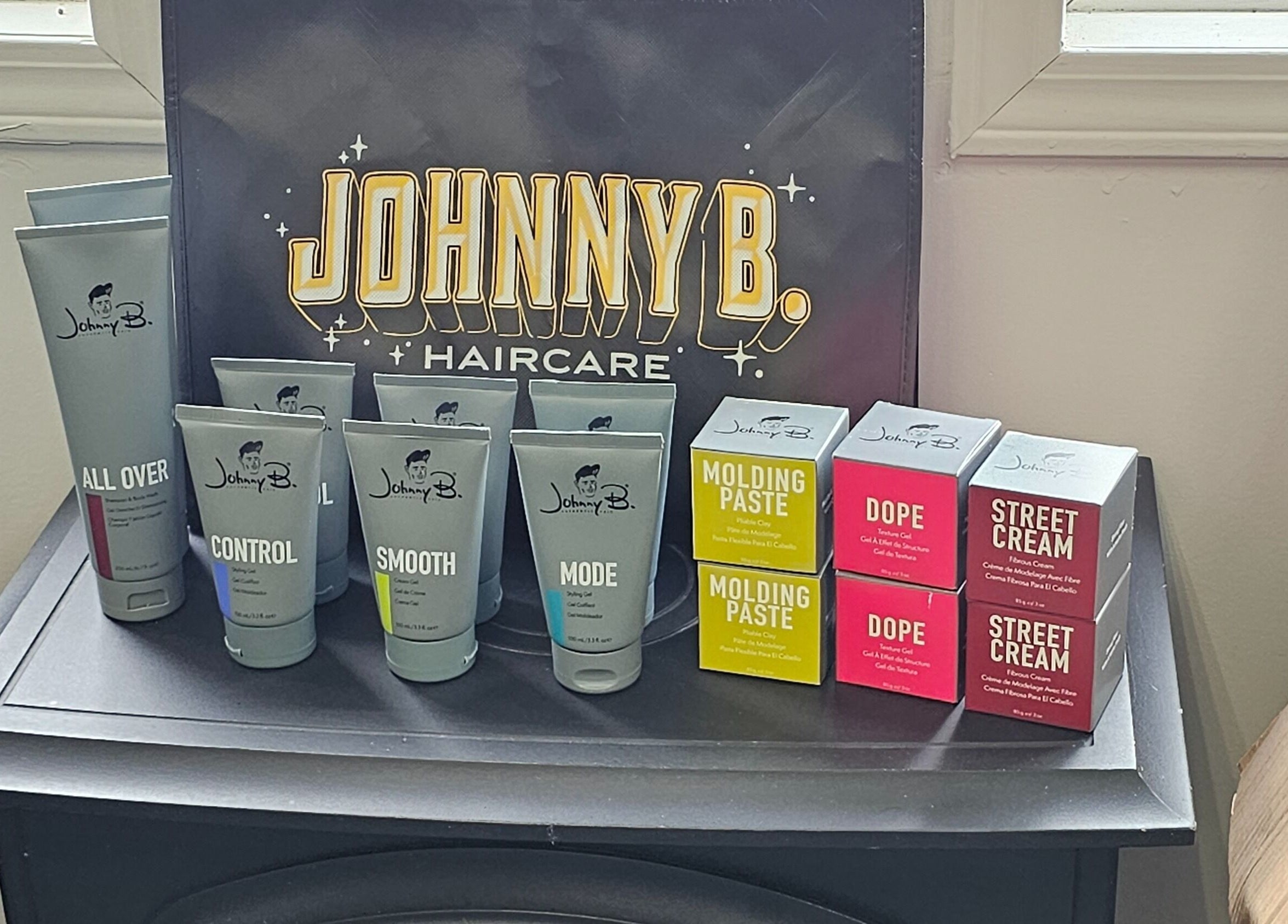 Johnny B hair products displayed at Canopy Salon and Spa, Innisfail, Alberta, CA, showcasing premium styling options.