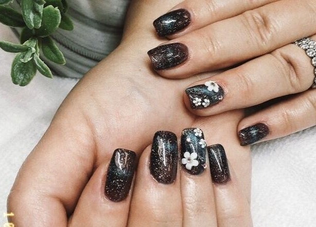 Elegant glittery nails with floral designs at Canopy Salon and Spa, Innisfail, Alberta, CA.