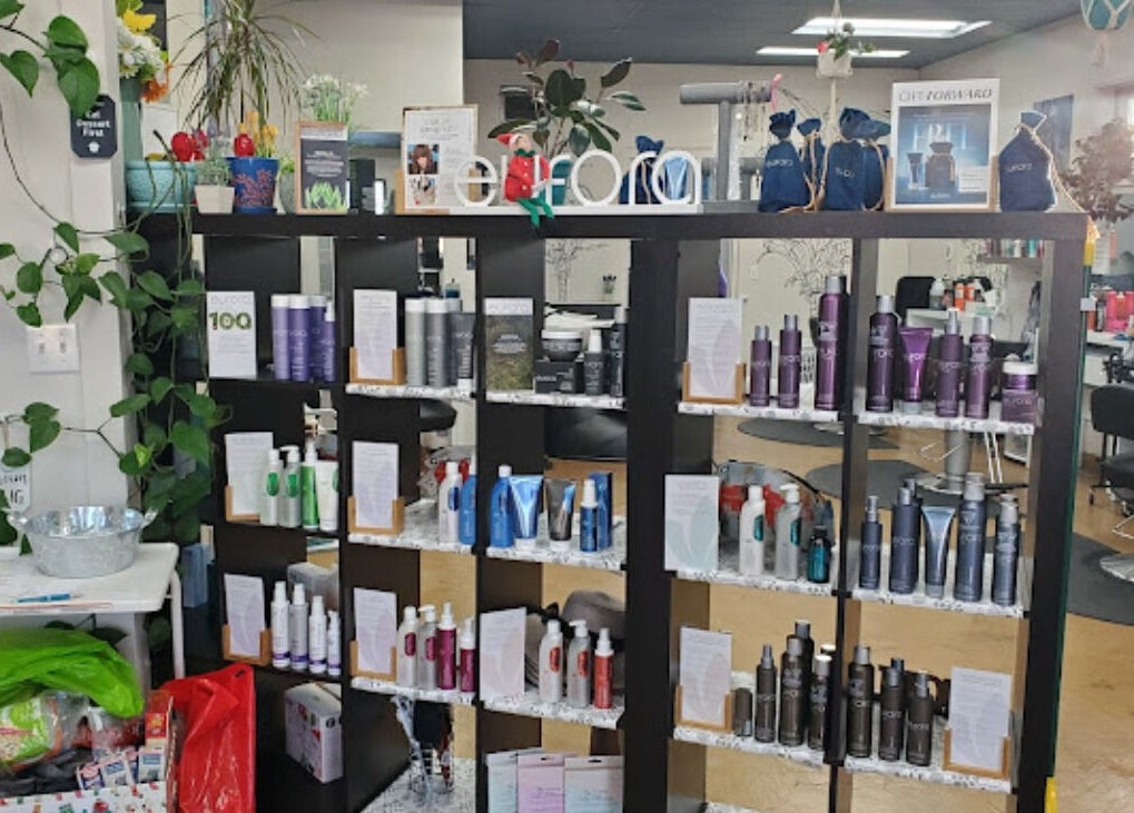 Shelves of beauty products at Canopy Salon and Spa, Innisfail, Alberta, CA, showcasing haircare and skincare items.