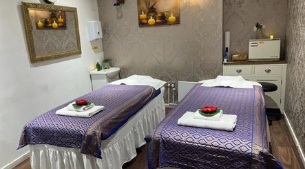 Inviting massage room at Kobkun Thai Spa in London, England, GB, with two adorned massage tables.