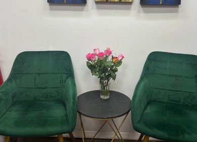 Green chairs and pink roses enhance tranquility at Kobkun Thai Spa, London, England, GB.