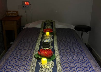 Massage table with floral decor at Kobkun Thai Spa, London, England, GB, offering a tranquil ambiance.