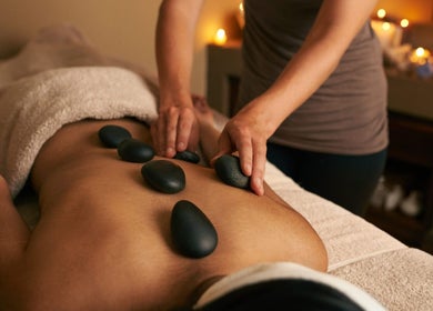 Relaxing hot stone massage at Kobkun Thai Spa, London, England, GB, enhancing tranquility and well-being.