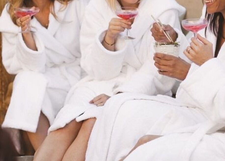 Guests enjoying drinks in white robes at Jinja, Devizes, England, GB wellness venue.