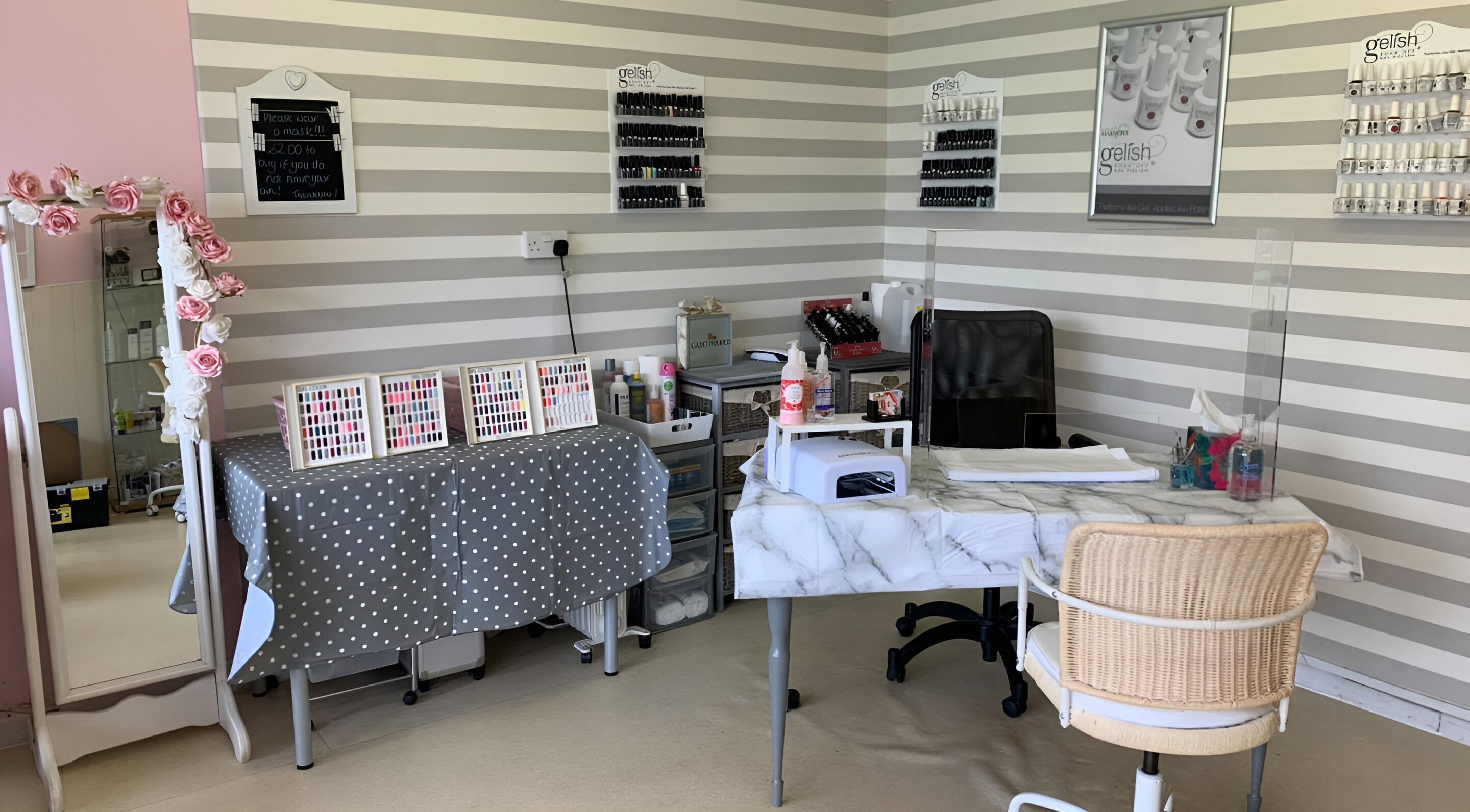 Elegant nail care station at Care Love Pamper Limited, Frodsham, England, GB, featuring a marble table and polish displays.