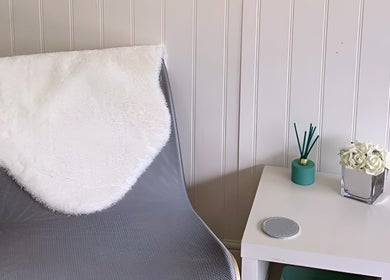 Cozy chair with fur throw at Care Love Pamper Limited, Frodsham, England, creating a serene atmosphere.