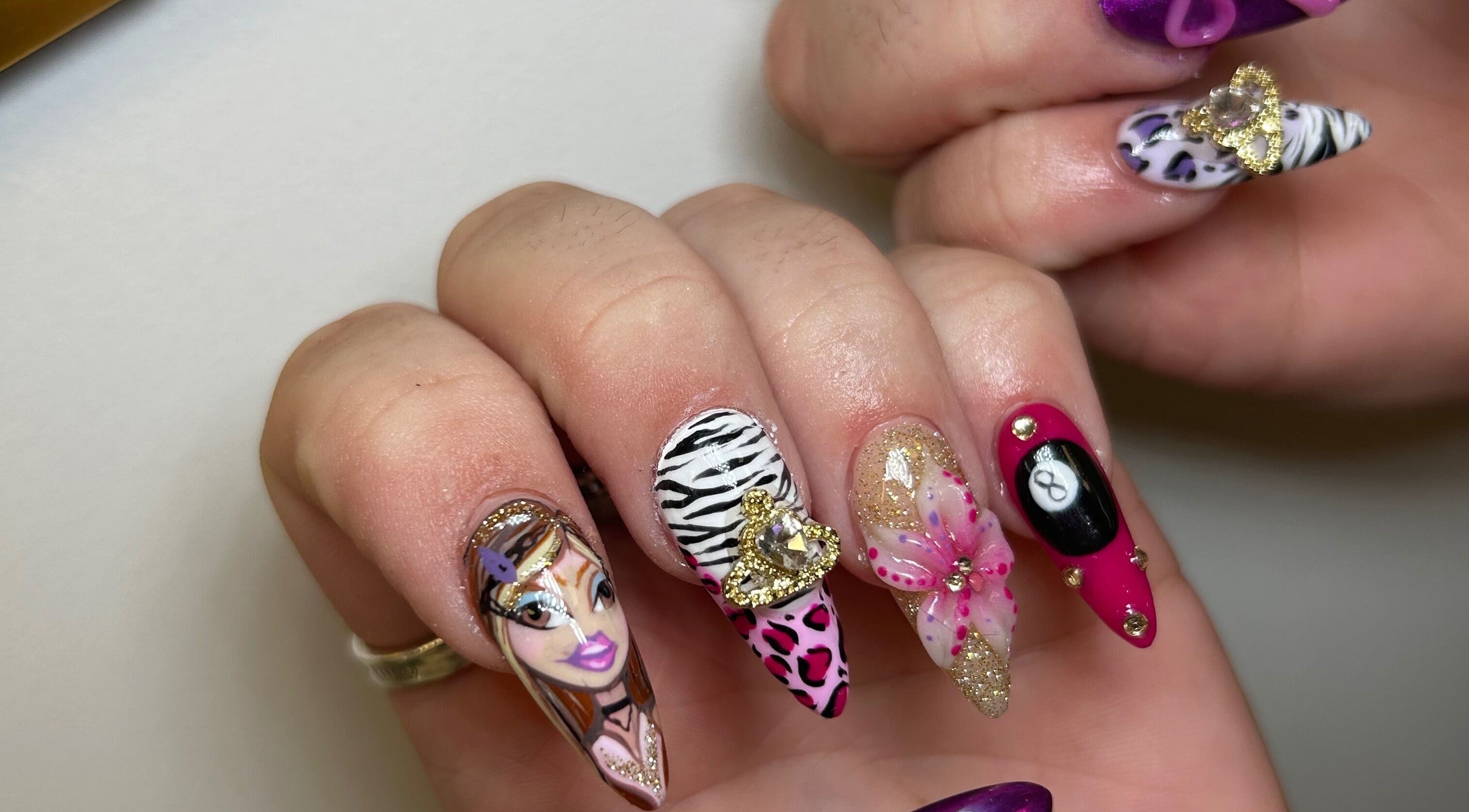 Stylish nail art at Infinite by Charlie Millard, Polesworth, England, GB. Bold, colorful designs on manicured nails.