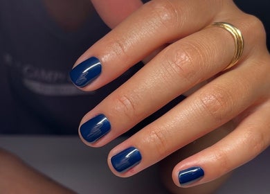 Close-up of elegant blue manicure at Nail Standards, Austin, Texas, US.