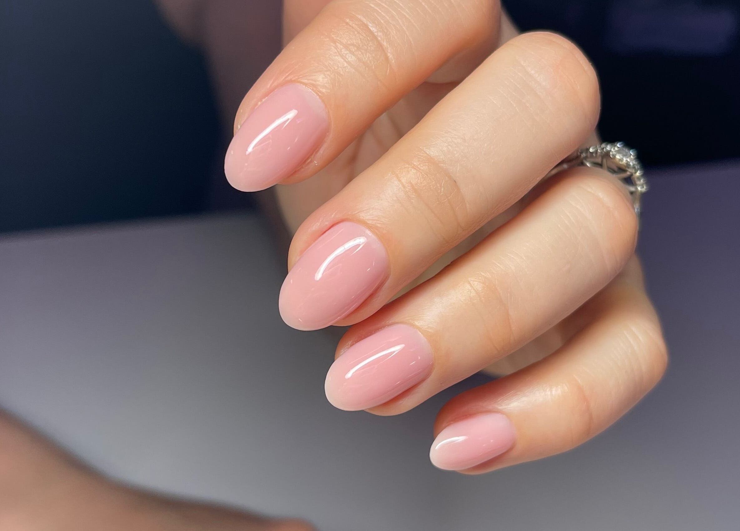 Close-up of elegantly manicured pink nails at Nail Standards in Austin, Texas, US.