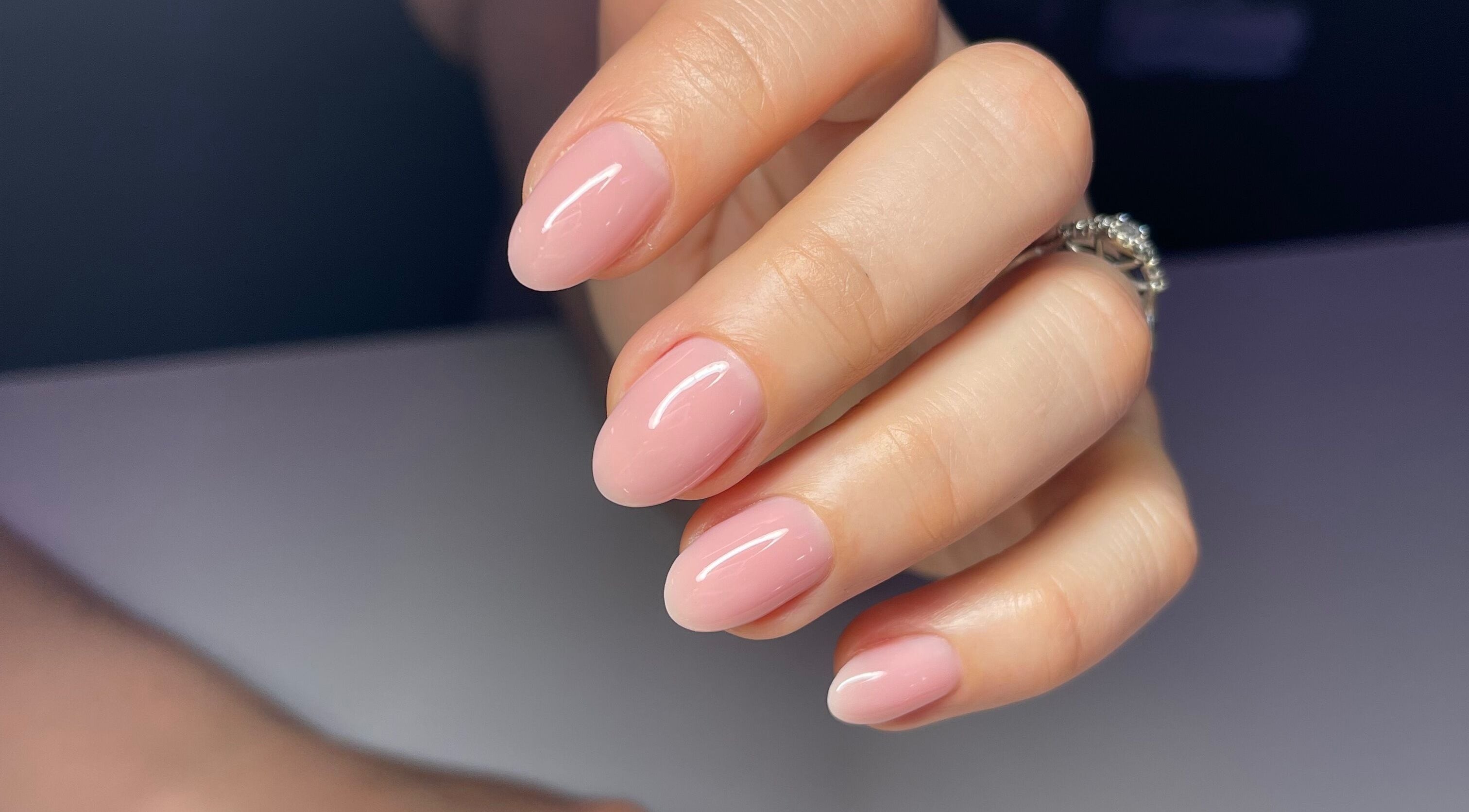 Close-up of elegantly manicured pink nails at Nail Standards in Austin, Texas, US.