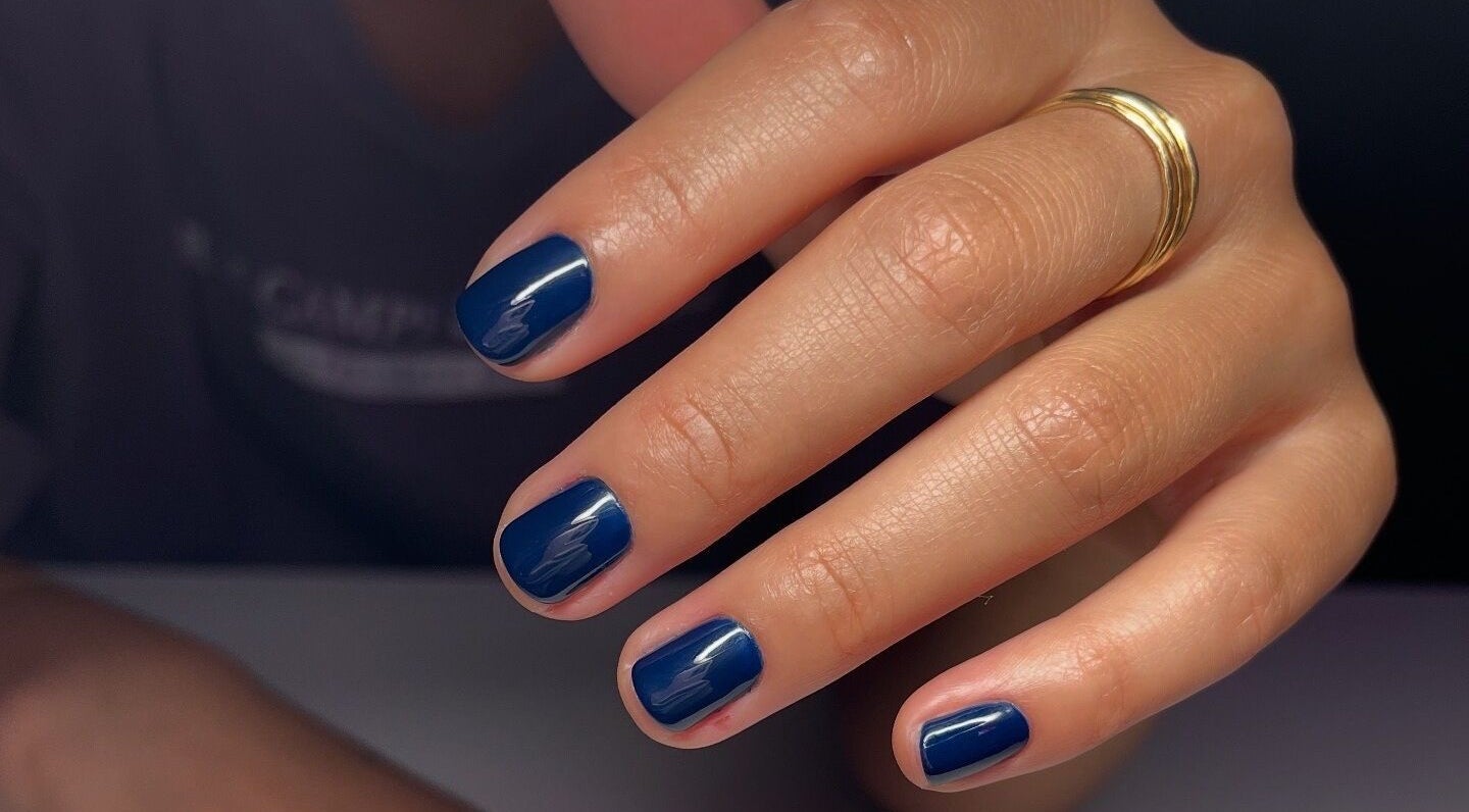 Blue polished nails at Nail Standards, Austin, Texas, US showcase chic and refined grooming.