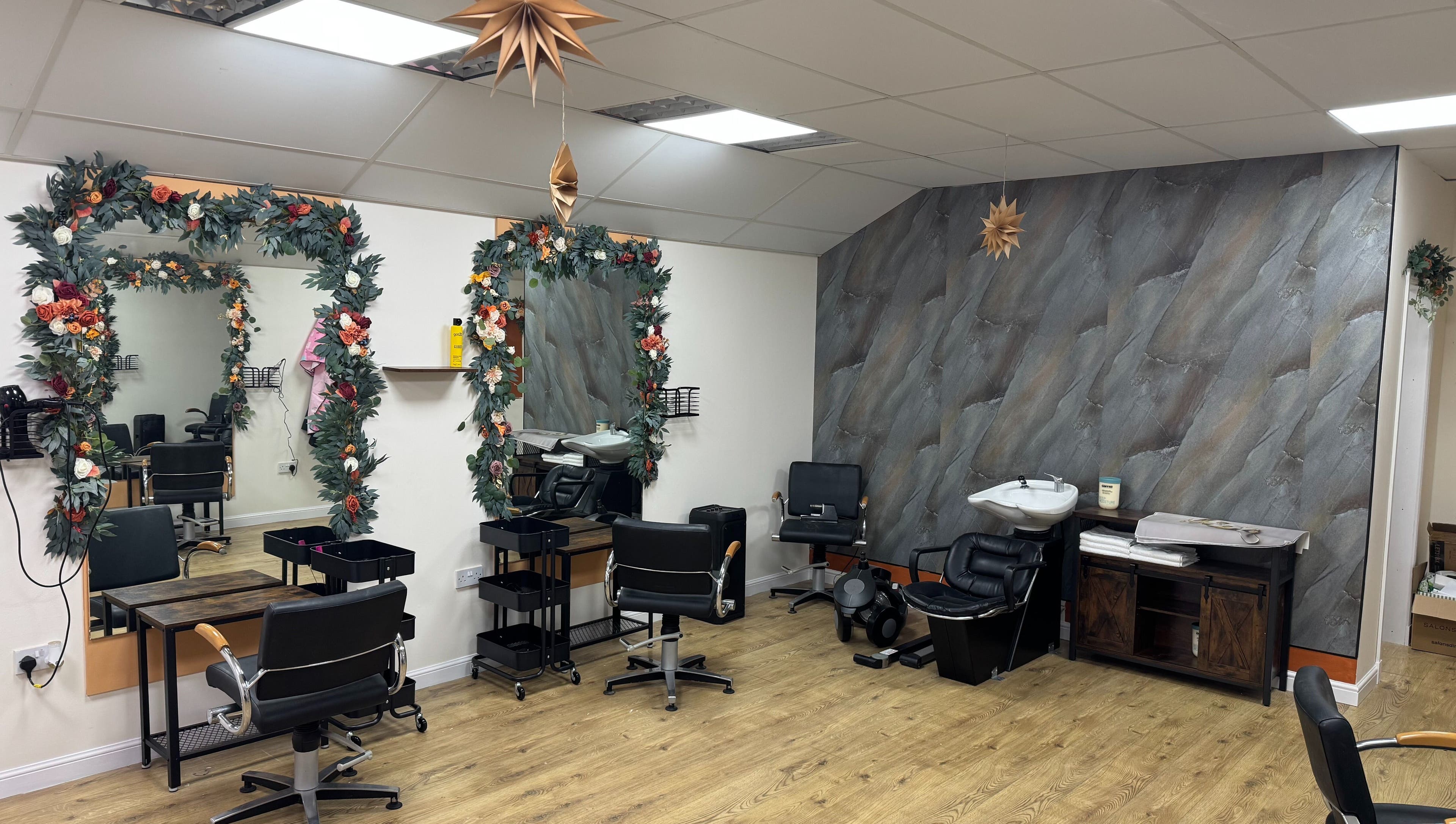 Stylish interior of Murphys Hair & Beauty Salon Limited in East Calder, Scotland, GB, featuring decorated mirrors.